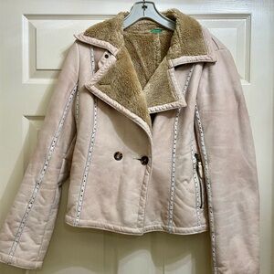 Suede with leather trim on the outside, button closures, furry lining inside.